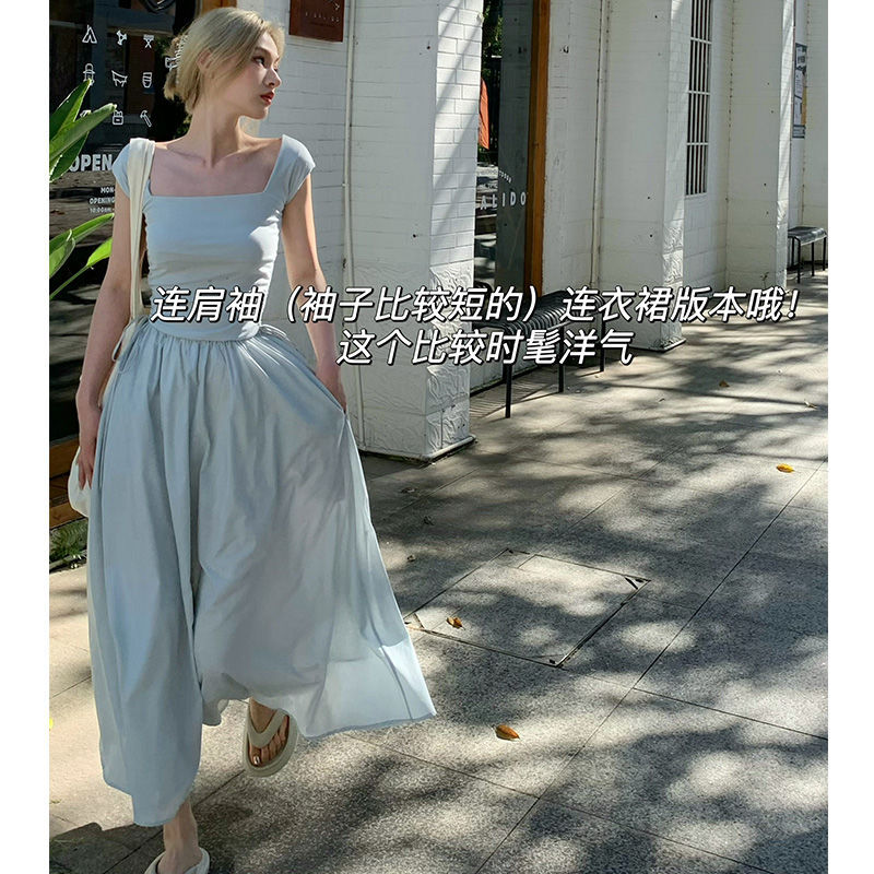 Woman in a light blue dress walking outdoors with text overlay
